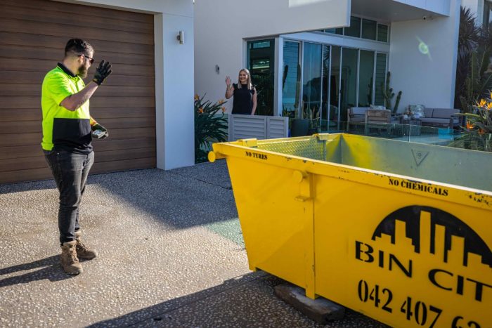 Man Waving Woman — Skips for Hire in Wollongong, NSW